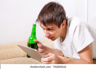 cheerful-young-man-beer-tablet-260nw-742828162.jpg
