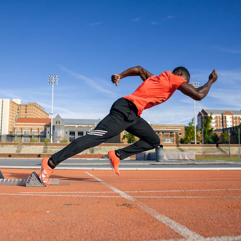 sprinter demonstrating block starts for track