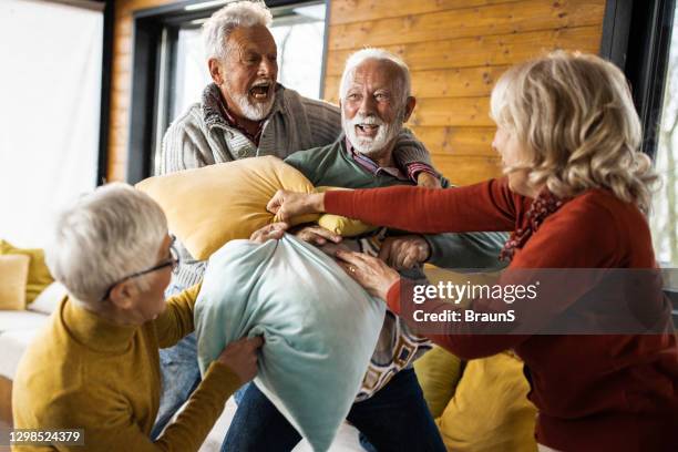 playful-mature-people-having-a-pillow-fight-at-home.jpg